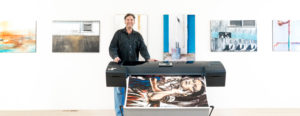 Mark standing next to a printer